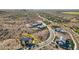 Expansive aerial view of luxury homes in a desert community with beautiful yellow flowering trees lining the roads at 17837 W Estes Way, Goodyear, AZ 85338