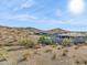 Desert home showcasing the backyard wall, landscaping, mountain views, and blue skies at 17837 W Estes Way, Goodyear, AZ 85338