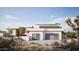 Stunning desert home with two-car garage and beautifully landscaped front yard, set against a bright blue sky at 17837 W Estes Way, Goodyear, AZ 85338
