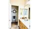 Bathroom vanity with oak cabinets, a large mirror, and tile flooring throughout at 17840 N Smith Dr, Maricopa, AZ 85139