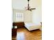 Bedroom with window, ceiling fan, wood-look flooring, and furniture at 17840 N Smith Dr, Maricopa, AZ 85139