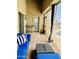 Inviting covered patio with wicker furniture, screened enclosure, and access to the outdoor pool at 17840 N Smith Dr, Maricopa, AZ 85139