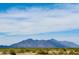 View of distant mountains across an expansive field, showcasing the natural landscapes surrounding the property at 17840 N Smith Dr, Maricopa, AZ 85139