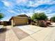 This lovely home has a three-car garage, a large driveway, and desert landscaping at 17840 N Smith Dr, Maricopa, AZ 85139