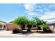 Charming home boasts desert landscaping, a three-car garage, and mature trees at 17840 N Smith Dr, Maricopa, AZ 85139