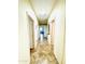 Inviting hallway with neutral colors, tile flooring, and doors leading to various rooms at 17840 N Smith Dr, Maricopa, AZ 85139