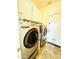 Functional laundry room features stainless steel washer and dryer, and overhead storage at 17840 N Smith Dr, Maricopa, AZ 85139