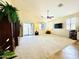 Open living room featuring a ceiling fan, neutral carpet, and lots of natural light at 17840 N Smith Dr, Maricopa, AZ 85139