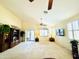 Spacious living room featuring neutral carpet, a ceiling fan, and lots of natural light at 17840 N Smith Dr, Maricopa, AZ 85139