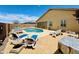 Inviting backyard pool and patio area with lounge chairs and a built in spa at 17840 N Smith Dr, Maricopa, AZ 85139