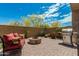 Beautiful outdoor seating area with a fire pit, stainless steel grill and desert landscaping at 1813 N Trowbridge --, Mesa, AZ 85207