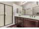 Bathroom with double sink vanity, framed mirrors, and a glass shower enclosure at 1813 N Trowbridge --, Mesa, AZ 85207