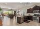 Open kitchen with stainless steel appliances, granite countertops, flowing into the living area at 1813 N Trowbridge --, Mesa, AZ 85207