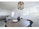 Cozy dining area adjacent to the living room with a wooden table and natural light from a window at 1825 W Ray Rd # 2074, Chandler, AZ 85224
