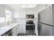Modern kitchen with stainless steel appliances, white cabinets, and bright natural light at 1825 W Ray Rd # 2074, Chandler, AZ 85224