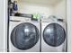 A laundry room features a modern, front-loading Samsung washer and dryer with convenient storage above at 1825 W Ray Rd # 2074, Chandler, AZ 85224
