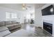 Inviting living room featuring a modern fireplace, a large couch, and an adjacent dining area at 1825 W Ray Rd # 2074, Chandler, AZ 85224