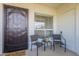 Cozy front patio with two chairs and a table, providing a welcoming outdoor seating area by the front door at 1825 W Ray Rd # 2074, Chandler, AZ 85224