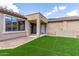 View of the backyard featuring artificial turf and a covered patio area at 1867 S Seton Ave, Gilbert, AZ 85295