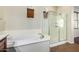 Bathroom featuring a soaking tub and separate glass shower at 1867 S Seton Ave, Gilbert, AZ 85295