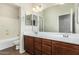 Bathroom featuring double sinks, brown cabinets and a large mirror at 1867 S Seton Ave, Gilbert, AZ 85295