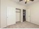 This bedroom has neutral carpet and walls and also features a closet and attached bath at 1867 S Seton Ave, Gilbert, AZ 85295