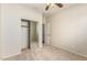 This bedroom features a mirrored closet, neutral carpet and walls, and a ceiling fan at 1867 S Seton Ave, Gilbert, AZ 85295