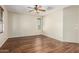 An open bedroom with wood-look flooring and neutral walls at 1867 S Seton Ave, Gilbert, AZ 85295