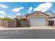 Exterior view of home with a two-car garage, brick wall, and desert landscaping at 1867 S Seton Ave, Gilbert, AZ 85295