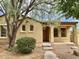 Inviting single-story home featuring a cozy porch and mature tree at 1867 S Seton Ave, Gilbert, AZ 85295