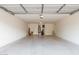 Spacious two-car garage with overhead lighting and concrete flooring at 1867 S Seton Ave, Gilbert, AZ 85295