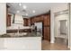 A spacious kitchen with granite countertops, stainless steel appliances, and dark wood cabinets at 1867 S Seton Ave, Gilbert, AZ 85295