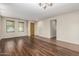 Open-concept living room with gorgeous hardwood floors and ample natural light at 1867 S Seton Ave, Gilbert, AZ 85295