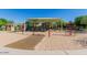 View of a community playground with swings and covered play structures at 1867 S Seton Ave, Gilbert, AZ 85295