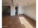 Expansive unfinished room features tile floors and bright natural light, offering remodeling and customization opportunities at 1916 N 22Nd St, Phoenix, AZ 85006