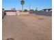 Spacious vacant lot surrounded by walls and a mature palm tree, ready for construction or landscaping at 1916 N 22Nd St, Phoenix, AZ 85006