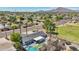 A beautiful aerial view of a home with a swimming pool, patio, and mountain views in a quiet neighborhood at 2045 N 68Th St, Scottsdale, AZ 85257