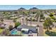 A stunning aerial view shows the backyard pool and patio of this home, set against a mountain backdrop at 2045 N 68Th St, Scottsdale, AZ 85257