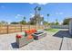 A spacious patio area with a comfortable seating arrangement and a modern fire pit, creating an inviting outdoor living space at 2045 N 68Th St, Scottsdale, AZ 85257