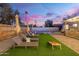 Spacious backyard features lounge chairs, a built-in bar, artificial grass, and a pristine pool at 2045 N 68Th St, Scottsdale, AZ 85257
