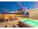 Backyard with a hot tub, patio with fire pit, outdoor seating, and relaxing ambiance with string lights at 2045 N 68Th St, Scottsdale, AZ 85257