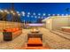 Inviting backyard with a fire pit, spa, lush landscaping, and string lights for an enchanting ambiance at 2045 N 68Th St, Scottsdale, AZ 85257