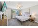 Bright bedroom featuring a queen-sized bed, ceiling fan, TV, and neutral decor at 2045 N 68Th St, Scottsdale, AZ 85257
