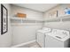 Functional laundry room with washer, dryer, and ample shelving for storage at 2045 N 68Th St, Scottsdale, AZ 85257
