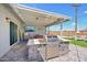 Charming outdoor kitchen featuring a stainless steel grill, brick facade, and covered dining area for entertaining at 2045 N 68Th St, Scottsdale, AZ 85257
