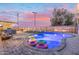 Lush backyard with a pool, swim toys, lounge chairs, and a built-in BBQ area for outdoor enjoyment at 2045 N 68Th St, Scottsdale, AZ 85257