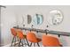 Chic vanity area with orange chairs, black countertop, and halo lit mirrors at 2045 N 68Th St, Scottsdale, AZ 85257