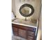 Charming bathroom vanity featuring dark wood and a unique oval mirror at 20660 N 40Th St # 2016, Phoenix, AZ 85050