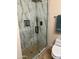Walk-in shower with marble tile and pebble floor with glass enclosure at 20660 N 40Th St # 2016, Phoenix, AZ 85050