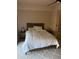 Bright bedroom with a ceiling fan, neutral walls, and white bedding at 20660 N 40Th St # 2016, Phoenix, AZ 85050